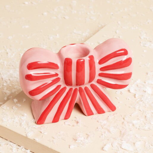 Close up of Pink and Red Stripe Bow Ceramic Candle Holder on a wintery neutral background