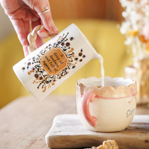 ceramic jug pouring milk