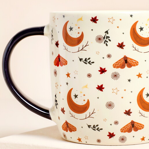 Close up of handle of Something Different Autumn Magic Ceramic Mug