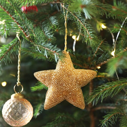 Beaded Star Hanging Decoration on a close up with tree and fairy lights