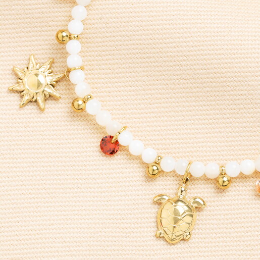 close up of coastal charms in gold