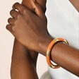 Stainless Steel Enamel Orange Bangle Bracelet in Gold
