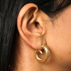 Stainless Steel Swirl Hoop Earrings in Gold on a neutral background