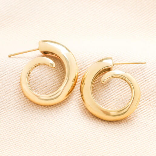 Stainless Steel Swirl Hoop Earrings in Gold on a neutral background