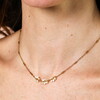 Triple Flower Barrel Chain Gold Necklace on a neutral background