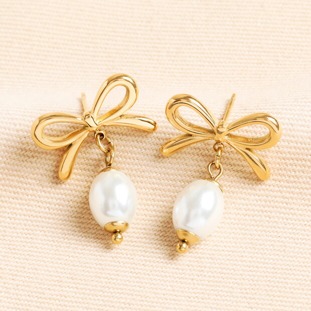 Stainless Steel Bow Pearl Drop Earrings in Gold Stainless Steel Bow Pearl Drop Earrings in Gold