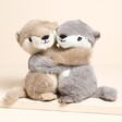 Warmies Warm Hugs Otters Microwavable Soft Toy together on a neutral background