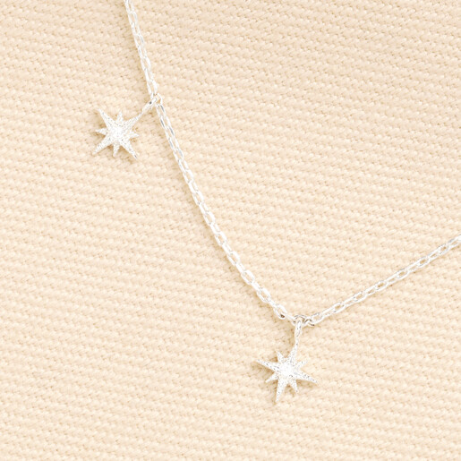 Detailed close-up of silver star charms set with clear cubic zirconia crystals.