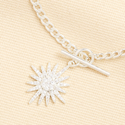 Close up of the sparkling cubic zirconia crystal starburst charm attached to a silver toggle clasp.
