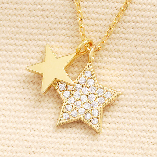 Close up of gold double star charms with clear cubic zirconia embellishments