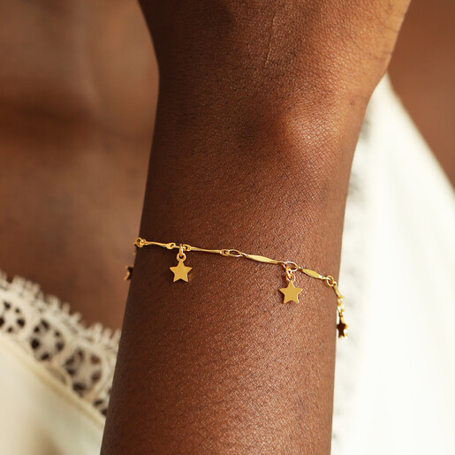 close up of gold charm necklace in gold