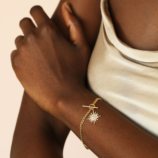 gold bracelet with star charm on model