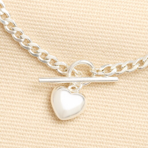 Close-up of the toggle clasp and polished silver heart pendant.