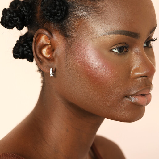 silver nature-inspired earrings on model