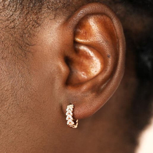 model close up of rose gold huggie hoop earrings