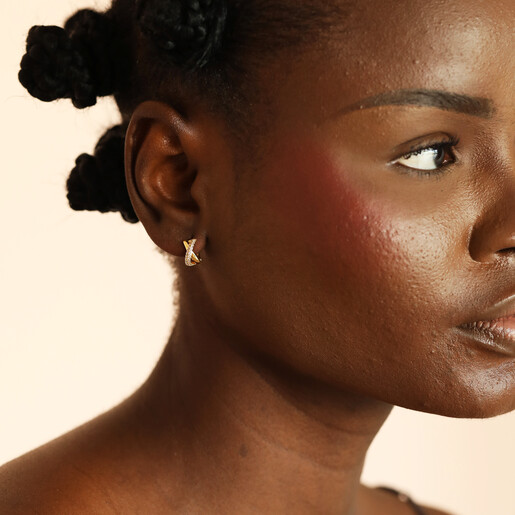 model shot of gold huggie hoop earrings