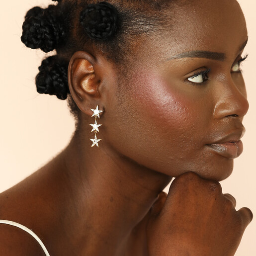 celestial-themed drop earrings on model in gold