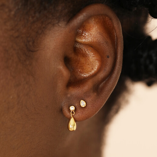 close up of food-inspired stud earrings in gold