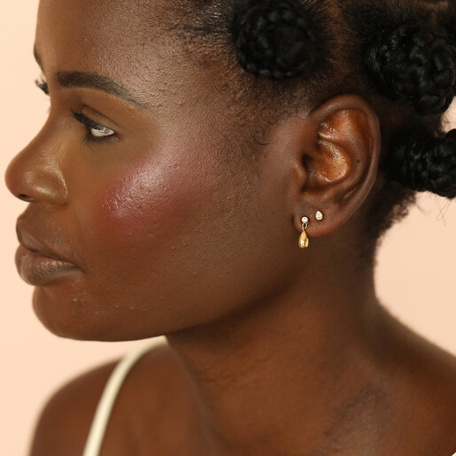 model shot of stud earrings in gold