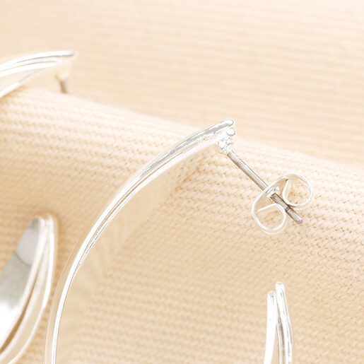 Close-up of titanium post and butterfly back on silver interlocking hoop earring