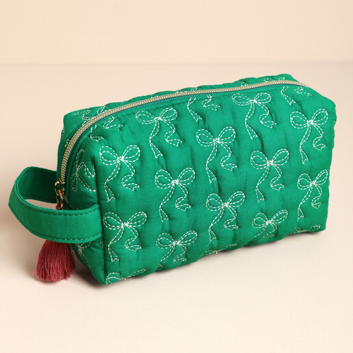 Green quilted makeup bag with white bow embroidery and carry handle