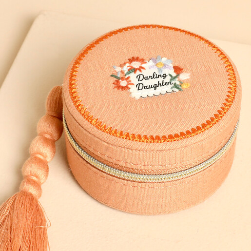 Close up of the embroidered Darling Daughter floral motif on the jewellery case