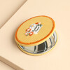 Open yellow fabric compact mirror showing internal mirror and embroidered Beautiful Friend cover.
