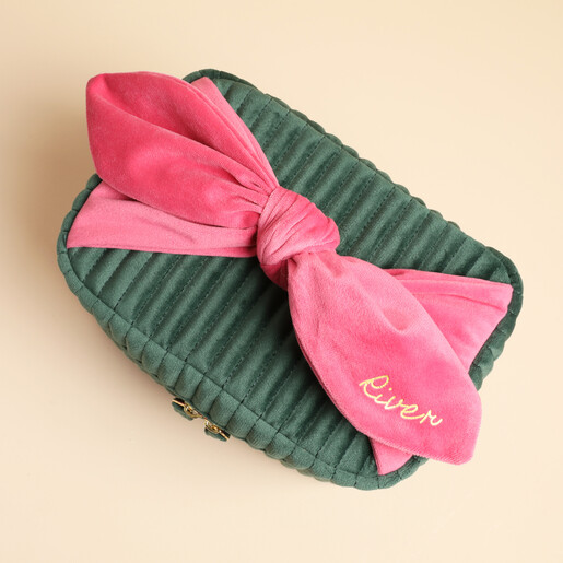 Top view of green velvet case featuring large pink bow personalised with River