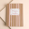 Front cover of pink and natural striped Dreams and Doodles fabric notebook