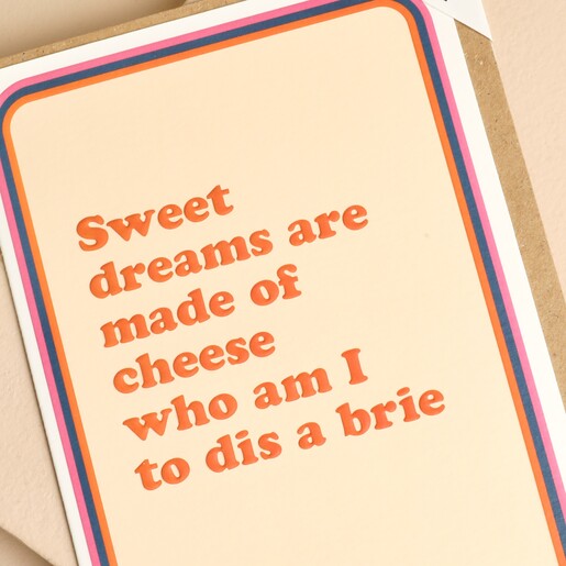 Close-up of retro orange text reading Sweet dreams are made of cheese