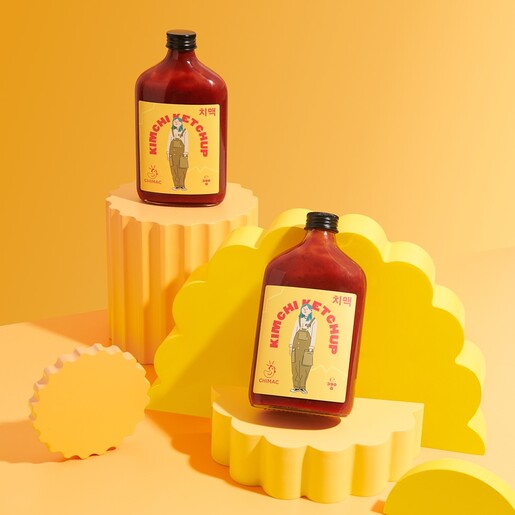 Chimac Kimchi Ketchup bottles styled on modern yellow stepped display stands
