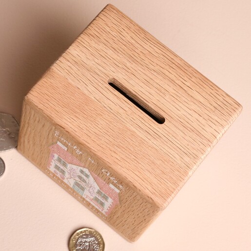 Top-down view of the wooden money box showing the coin slot