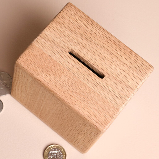 Top view of wooden cube money box showing the coin slot