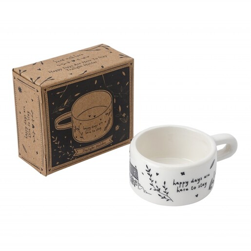 White ceramic mug tealight holder next to its illustrated kraft packaging box.