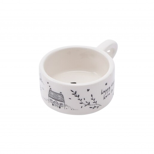 Side view of white ceramic tealight holder showing black house and leaf illustrations.