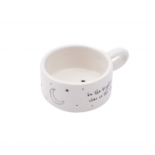 Side view of white ceramic tealight holder with moon and star illustration