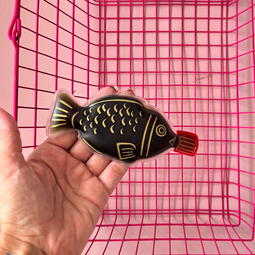House of Disaster fish shaped soy sauce hand warmer held in a hand