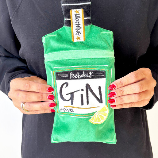 House of Disaster green gin bottle shaped hot water bottle held in two hands
