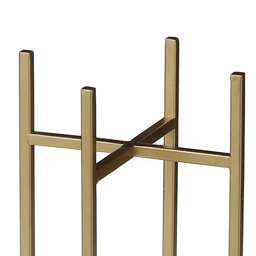 Close-up of the crossbar design on the gold metal plant stand.