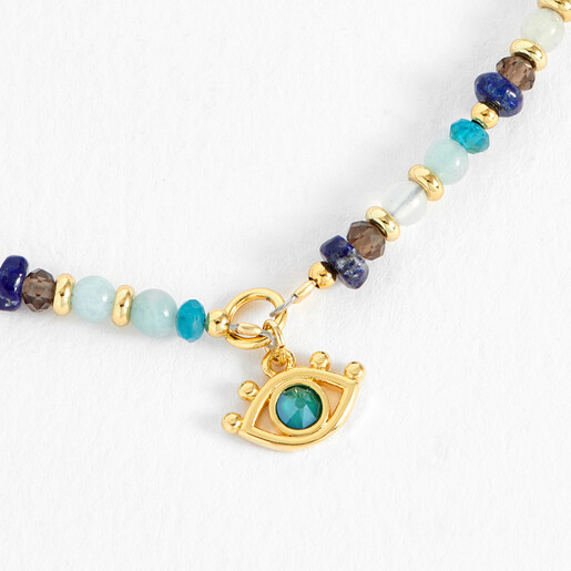 Close-up of the gold evil eye charm with turquoise centre on beaded bracelet