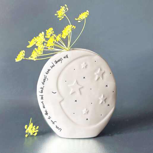 Round white ceramic moon vase styled with yellow dried flowers
