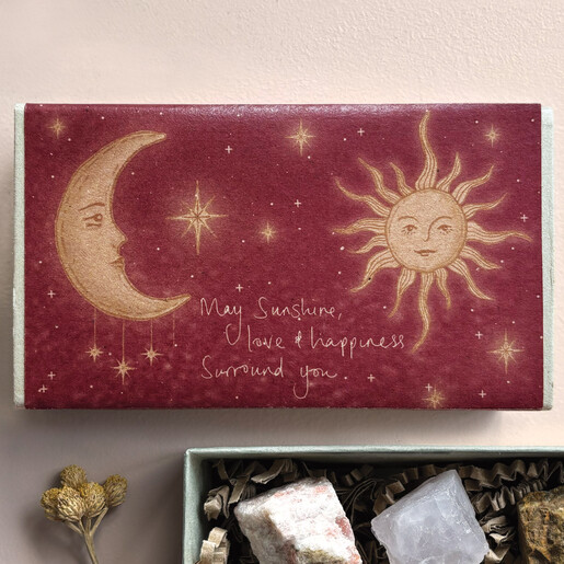Deep red East of India matchbox with celestial sun and moon illustration
