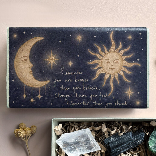 Close-up of celestial sun and moon illustration with motivational quote
