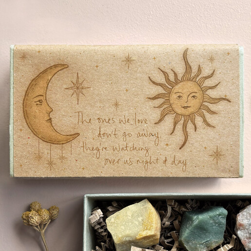 Close-up of celestial sun and moon illustration with sentimental quote on the slide box.