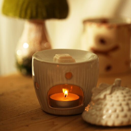 Cosy evening room styling with glowing ceramic acorn wax melt burner