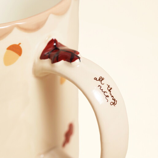 Close-up of the mug handle showing a 3D leaf and all things nice script