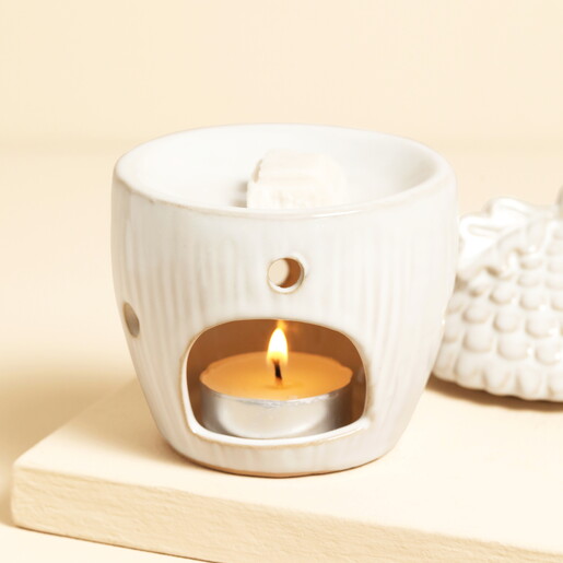 Ceramic acorn wax burner with lit tealight inside and wax melt in dish