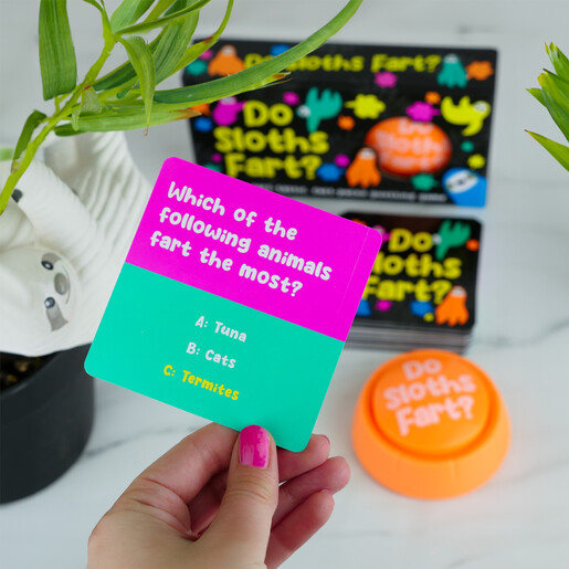 Hand holding a colourful multiple-choice trivia card from the Do Sloths Fart game.