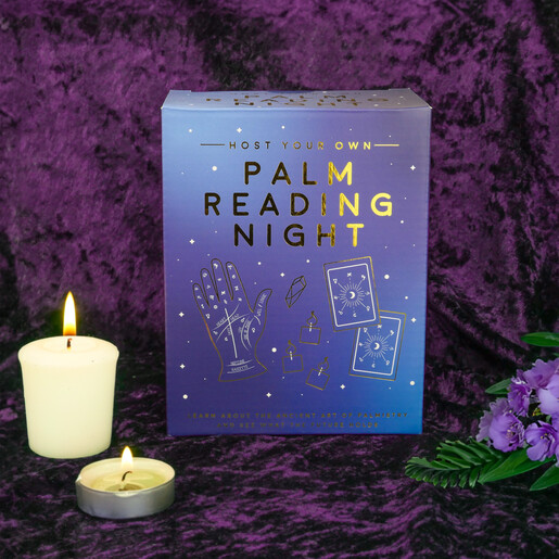 Host Your Own Palm Reading Night illustrated packaging box beside glowing candles