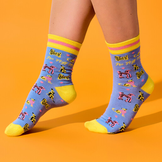 Model wearing the blue and yellow dog patterned crew socks